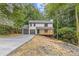 Charming two-story home featuring a welcoming porch, a two-car garage, and landscaping to be completed at 2599 Willow Creek Dr, Duluth, GA 30096
