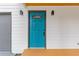 Close-up of the vibrant blue front door, flanked by modern sconces and gray garage door at 2599 Willow Creek Dr, Duluth, GA 30096