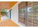 Inviting front porch with wood floors and white siding, complemented by large windows and a bright blue front door at 2599 Willow Creek Dr, Duluth, GA 30096