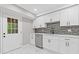 Stylish kitchen featuring white cabinets, stainless steel dishwasher and hardware, and light countertops at 2599 Willow Creek Dr, Duluth, GA 30096