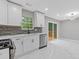 Contemporary kitchen featuring white cabinets, stainless steel appliances, and access to outdoor deck at 2599 Willow Creek Dr, Duluth, GA 30096