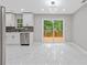 Modern kitchen featuring white cabinets, stainless steel appliances, and a sliding door to the patio at 2599 Willow Creek Dr, Duluth, GA 30096