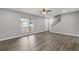 Bright living room featuring hardwood floors, large windows, and a view of the front porch at 2599 Willow Creek Dr, Duluth, GA 30096