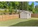 The fenced backyard has a well-maintained lawn and a shed at 272 Broadstone Blvd, Acworth, GA 30101