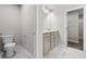 Elegant bathroom featuring double sinks with granite countertops, marble floors, and a view to the walk-in closet at 272 Broadstone Blvd, Acworth, GA 30101