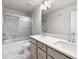 Beautiful bathroom featuring marble tile, a dual sink vanity, and a tub-shower combo with sliding doors at 272 Broadstone Blvd, Acworth, GA 30101