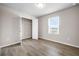 This bedroom features wood-look flooring, closet with open door, and a window at 272 Broadstone Blvd, Acworth, GA 30101