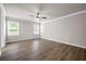 Spacious bedroom featuring two windows that bring in natural light, crown molding, and hardwood floors at 272 Broadstone Blvd, Acworth, GA 30101