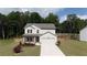 Charming two-story home with manicured lawn and a two car garage at 272 Broadstone Blvd, Acworth, GA 30101