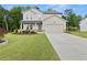 Charming two-story home with a manicured lawn and a two car garage at 272 Broadstone Blvd, Acworth, GA 30101