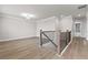 Bright hallway featuring hardwood floors and neutral paint, adjacent to the staircase overlooking the lower level at 272 Broadstone Blvd, Acworth, GA 30101