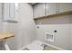 This laundry room features ample shelving and utility hookups at 272 Broadstone Blvd, Acworth, GA 30101