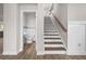 Bright entryway featuring stairs with wood treads, a wooden handrail, and a powder room with marble accents at 272 Broadstone Blvd, Acworth, GA 30101