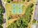Aerial view of basketball courts surrounded by green space, trees and walking paths at 414 Dogwood Way, Canton, GA 30114
