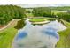 Scenic aerial view of a golf course with a water hazard and surrounding lush greenery at 414 Dogwood Way, Canton, GA 30114