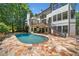 Scenic backyard view of a sparkling pool and a home with stairs to a deck at 414 Dogwood Way, Canton, GA 30114
