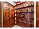 Wooden shelving and door with shelves displaying glassware, bottles, and collectable mugs at 414 Dogwood Way, Canton, GA 30114