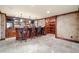 A custom bar area featuring a wooden bar, brick accents, shelving, and travertine tile flooring at 414 Dogwood Way, Canton, GA 30114