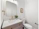 Stylish half-bath with a modern vanity and gold hardware at 414 Dogwood Way, Canton, GA 30114