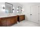 Bathroom featuring dual vanities, sleek mirrors, modern fixtures, and white marble floors at 414 Dogwood Way, Canton, GA 30114