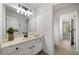 Bright bathroom with tile floors, white vanity, and a view to the hallway at 414 Dogwood Way, Canton, GA 30114