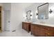 Elegant bathroom with dual vanities, wooden cabinets, marble floors, and modern lighting at 414 Dogwood Way, Canton, GA 30114