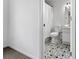 Clean bathroom with patterned tile flooring, white fixtures, and a shower with curtain at 414 Dogwood Way, Canton, GA 30114