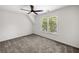 A bedroom is carpeted with a ceiling fan and a large window providing natural light and a view at 414 Dogwood Way, Canton, GA 30114