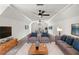 Open-concept bonus room with plush carpeting, couches, and a mounted tv at 414 Dogwood Way, Canton, GA 30114