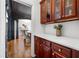 A beautiful butlers pantry with dark wood cabinets, white countertop and view of the dining room at 414 Dogwood Way, Canton, GA 30114