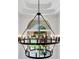 A modern chandelier hangs from the ceiling with view through an arched window at 414 Dogwood Way, Canton, GA 30114
