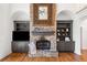 Stone fireplace with custom built-in shelves, hardwood floors, and recessed lighting at 414 Dogwood Way, Canton, GA 30114