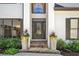 Elegant front entrance with a decorative door, stone steps, lush plants, and detailed architecture at 414 Dogwood Way, Canton, GA 30114