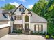 Elegant home featuring a stone walkway, lush landscaping, and an attached garage at 414 Dogwood Way, Canton, GA 30114