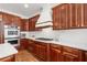 Close-up of the gourmet kitchen showcasing modern appliances, countertops, and wood cabinetry at 414 Dogwood Way, Canton, GA 30114
