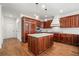 Gourmet kitchen boasts stainless steel appliances, ample cabinet space, a center island and hardwood floors at 414 Dogwood Way, Canton, GA 30114