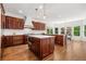 Spacious kitchen features a center island, hardwood floors, stainless steel appliances, and a bright breakfast nook at 414 Dogwood Way, Canton, GA 30114