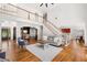 Open concept living room showcasing hardwood floors, elegant staircase, and dining area at 414 Dogwood Way, Canton, GA 30114