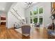 Living room showcasing stone fireplace, built-in shelves, hardwood floors, and ample natural light at 414 Dogwood Way, Canton, GA 30114