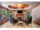 Sunroom with decorative windows, fireplace, and two leather chairs at 414 Dogwood Way, Canton, GA 30114
