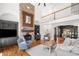 Bright living room with a stone fireplace, built-in bookshelves, and open layout to the dining area at 414 Dogwood Way, Canton, GA 30114