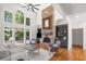 Inviting living room with high ceilings, large windows, and a cozy seating area with stone fireplace at 414 Dogwood Way, Canton, GA 30114