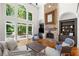 Stunning living room with soaring windows, a stone fireplace, and views of the outdoor deck at 414 Dogwood Way, Canton, GA 30114