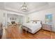 Spacious main bedroom with a sitting area, fireplace, hardwood floors, and natural light at 414 Dogwood Way, Canton, GA 30114