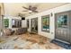 Covered outdoor patio with stone floor, ceiling fans, seating, and natural light at 414 Dogwood Way, Canton, GA 30114