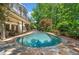 Backyard pool with stone surround, patio furniture and lush landscaping at 414 Dogwood Way, Canton, GA 30114