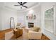 Cozy sitting room with a fireplace, hardwood floors, comfortable seating, and natural light at 414 Dogwood Way, Canton, GA 30114