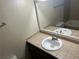 Well-lit bathroom featuring vanity sink, mirror and coordinated tile at 6956 Kimberland Gardens Ln, Lithonia, GA 30058