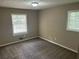 Comfortable bedroom with two windows and neutral carpet at 6956 Kimberland Gardens Ln, Lithonia, GA 30058