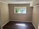 Bedroom with dark floors, wood paneling, and a window for natural light at 6956 Kimberland Gardens Ln, Lithonia, GA 30058